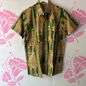 May include: A green and yellow striped short-sleeved button-up shirt with a tiger print.