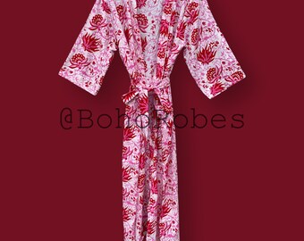 May include: A pink and red floral print robe with a tie waist. The robe is hanging on a white hanger against a red background. The text "@boho_robes" is visible in the lower center of the image.