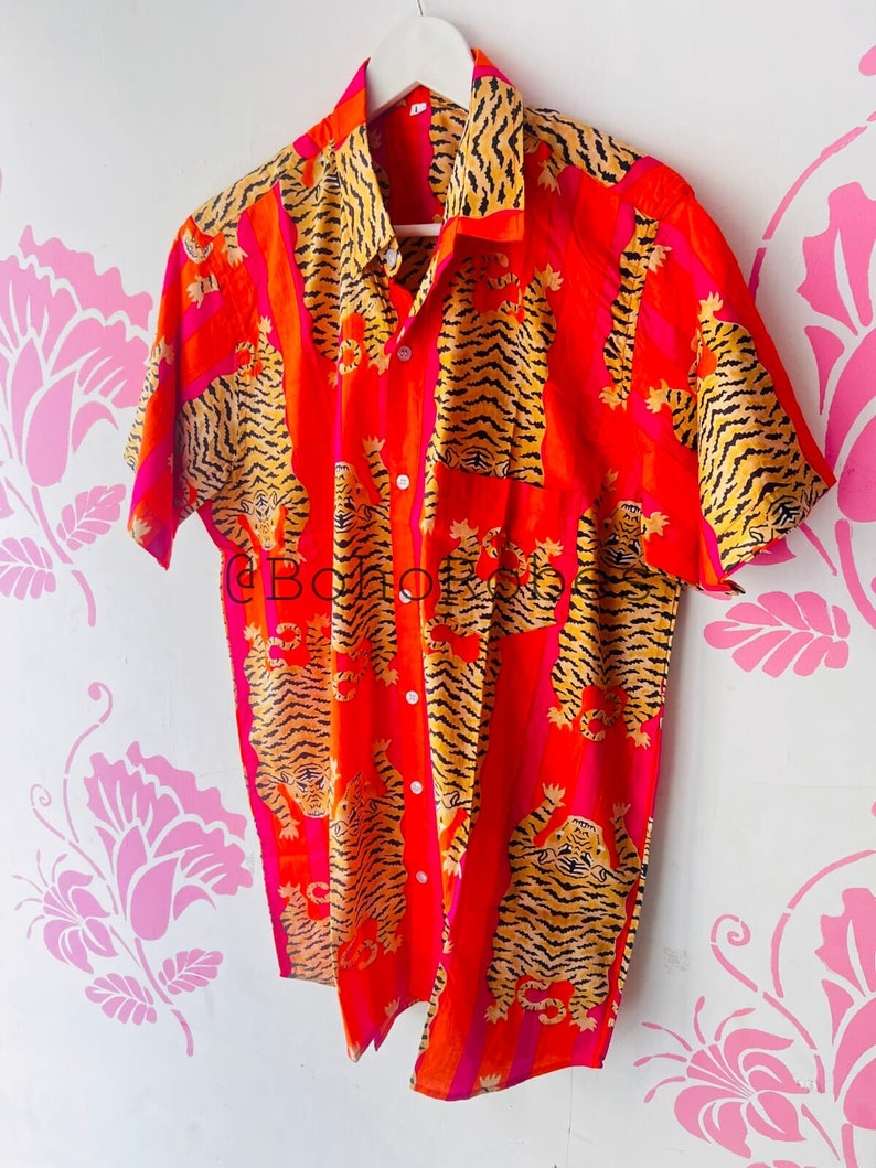 May include: A red and pink short-sleeved button-up shirt with a tiger print.
