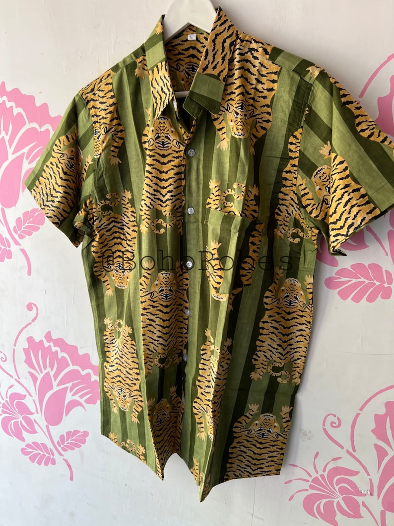 May include: A green and orange short-sleeved button-up shirt with a tiger print pattern.