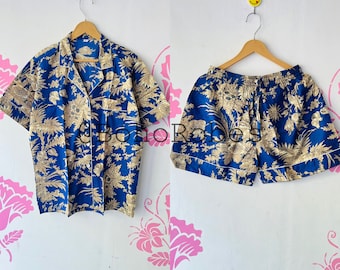 May include: A blue and gold floral print pajama set with a short-sleeved button-up shirt and matching shorts.
