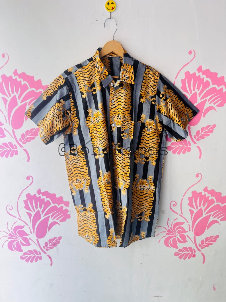 May include: A short-sleeved button-down shirt with a striped pattern and a tiger print. The shirt is blue, black, and yellow.