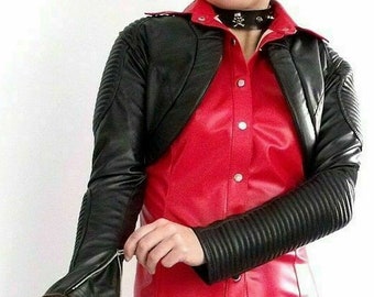 May include: A black leather cropped jacket with long sleeves and a zipper detail. The jacket has a quilted design on the sleeves and a pointed collar. The jacket is worn over a red satin shirt with a button-up front.