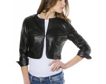 May include: A black leather jacket with a zipper closure and three-quarter sleeves. The jacket is cropped at the waist.