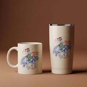 May include: A cream-colored coffee mug and tumbler featuring a vintage-style illustration of a rodeo rider on a horse. The design includes the text "Rootin' Tootin' Club" in red and blue, with a cowboy roping a steer.