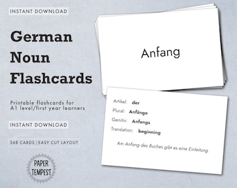 May include: Printable German noun flashcards for A1 level learners. The card shows the word "Anfang" with its grammatical information, translation, and example sentence: "Artikel: der, Plural: Anfänge, Genitiv: Anfangs, Translation: beginning, Am Anfang des Buches gibt es eine Einleitung."
