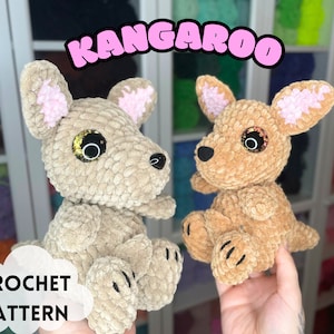 May include: Two crocheted kangaroo plushies, one in beige and one in brown, with pink ears and sparkly eyes. The plushies are sitting on a hand. The image includes the text "Kangaroo Crochet Pattern".