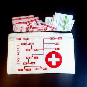 May include: A white canvas first aid kit with a black zipper, filled with bandages and alcohol prep pads. The kit features a red cross symbol and a diagram in red, with the words "FIRST AID KIT" printed on the side.