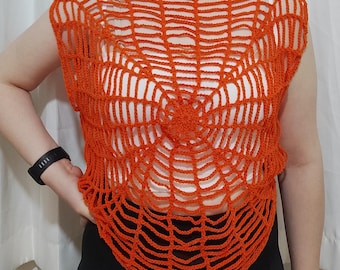 May include: Orange crochet top with a spiderweb design. The top is sleeveless and has a round neckline.