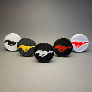 May include: Five circular emblems featuring a running horse silhouette. The set includes a white emblem with a black horse, a black emblem with a yellow horse, a black emblem with a white horse, a black emblem with a red horse, and a white emblem with a red horse.