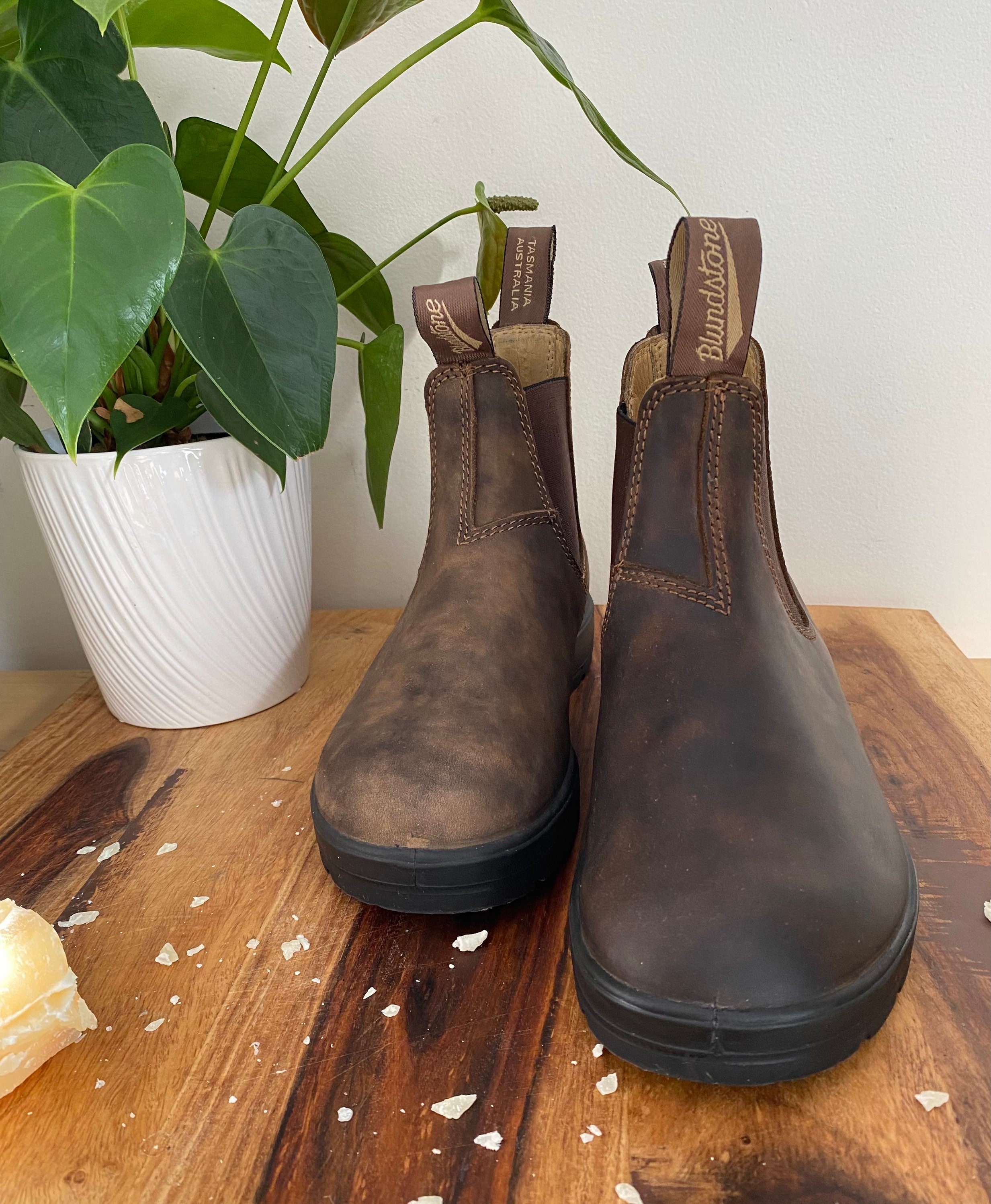 polishing boots with beeswax