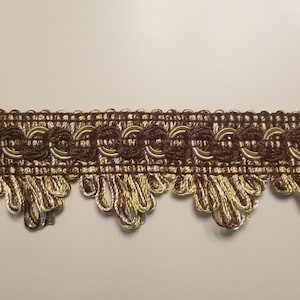May include: Brown and gold trim with a scalloped edge. The trim has a repeating pattern of circles and a woven texture.