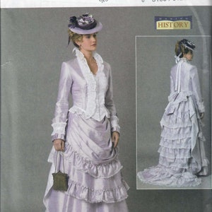 May include: A vintage sewing pattern for a long, lilac-colored dress with a lace trim and a ruffled skirt. The pattern is from Butterick and is for sizes 14-16-18-20-22. The pattern is titled "Making History".