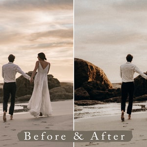 May include: A couple in wedding attire walk hand-in-hand on a sandy beach with large rocks in the background. The sky is a soft, pale orange and the couple are walking towards the setting sun.