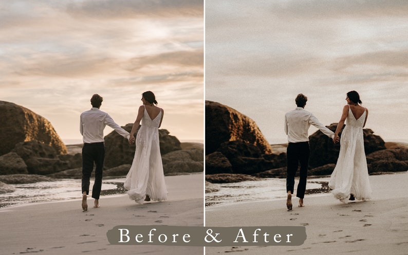 May include: A couple in wedding attire walk hand-in-hand on a sandy beach with large rocks in the background. The sky is a soft, pale orange and the couple are walking towards the setting sun.