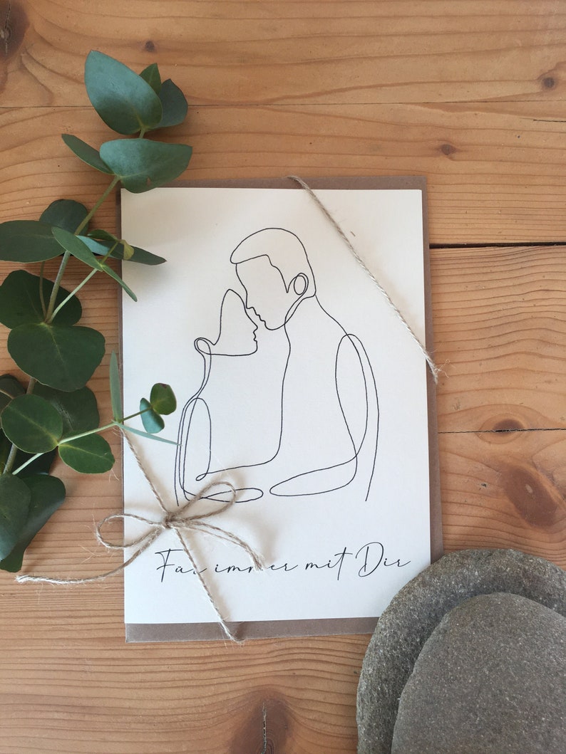 May include: A simple line drawing of a couple embracing, with the text "For immer mit Dir" on a brown card.