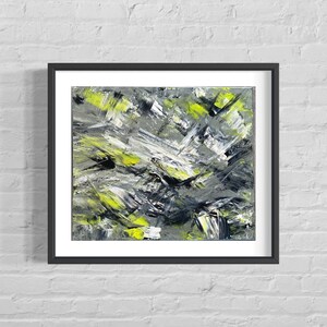 May include: Abstract painting in a black frame. The painting features a mix of gray, black, and yellow paint strokes. The strokes are thick and textured, creating a dynamic and energetic composition.