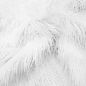 May include: White faux fur fabric with a soft, fluffy texture. The fur is arranged in a wavy pattern, creating a luxurious and cozy look.