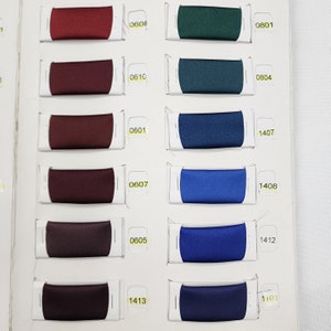 May include: A color chart with fabric swatches in various shades of red, green, blue, and black. The swatches are labeled with numbers, including 0608, 0610, 0601, 0607, 0605, 1413, 0801, 0804, 1407, 1408, 1412, and 1401.