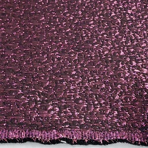 May include: Close-up of a deep purple fabric with a textured, woven pattern. The fabric has a subtle shimmer and a slightly raised edge.