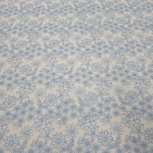 May include: Light blue floral embroidery on a sheer white fabric. The embroidery features a variety of flower shapes and sizes, creating a delicate and intricate pattern.