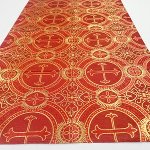 May include: Red fabric with a gold cross pattern. The fabric has a repeating pattern of circles with a cross in the center. The circles are surrounded by a decorative border.