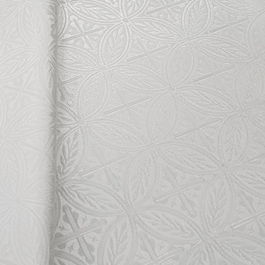 May include: White fabric with a raised embossed pattern of repeating circles and leaves.