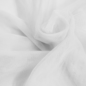 May include: White tulle fabric with a soft, delicate texture. The fabric is sheer and has a fine mesh pattern.