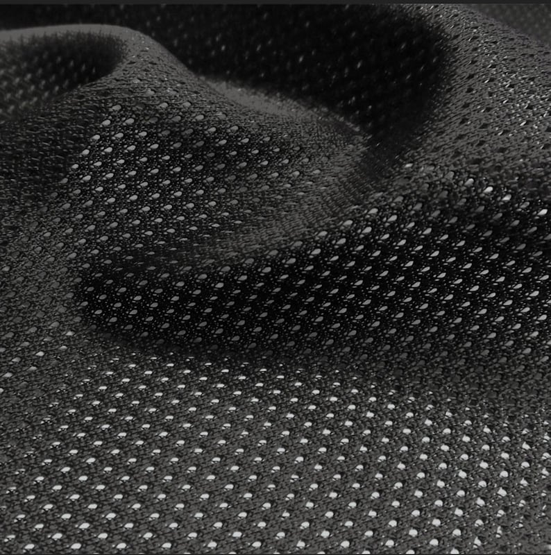 Op de afbeelding: Zwart mesh-stof met een klein, herhalend patroon van gaten. De stof is zacht en flexibel en heeft een licht getextureerd oppervlak.