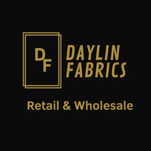 Puede incluir: Logotipo dorado con las letras "DF" dentro de un cuadrado de doble línea. El texto "DAYLIN FABRICS" está a la derecha del logotipo. Debajo del logotipo está el texto "Retail & Wholesale".