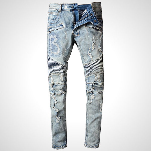 Jean bleu clair vintage pour hommes déchiré, troué et déchiré. Denim stretch coupe slim.