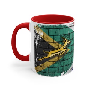 South African Flag against a brick wall with Springbok Accent Coffee Mug, 11oz