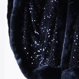 May include: Black sequined fabric with a black fur trim. The fabric is soft and luxurious, and the fur is thick and plush.