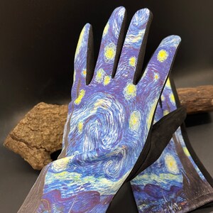 May include: A pair of gardening gloves featuring a print of Van Gogh's "Starry Night" painting. The gloves have a blue and yellow swirling design with black accents on the fingers and cuffs. The gloves are designed for outdoor use.