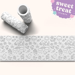 May include: White rolling pin with a spring-themed pattern, featuring birds, flowers, rainbows, and clouds. The image also shows a matching embossed pattern. The text "sweet treat STAMPS" is in the upper right corner.