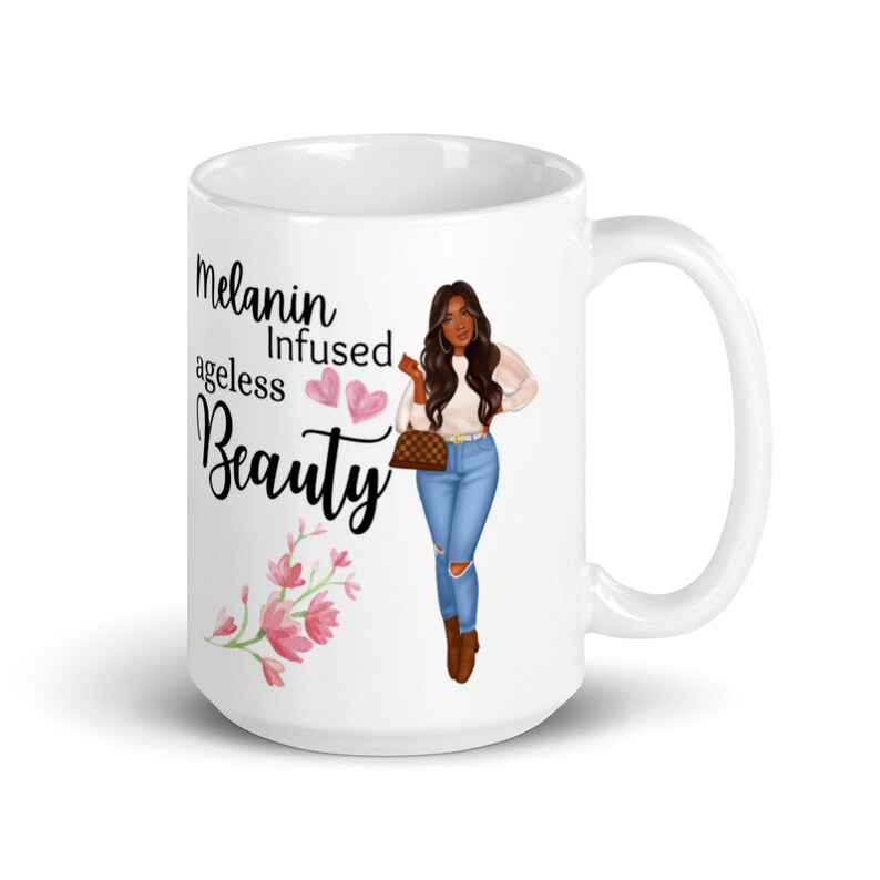 May include: White ceramic mug with a black and pink design. The mug features a cartoon illustration of a woman with brown skin and long brown hair. The text on the mug reads "Melanin Infused Ageless Beauty".