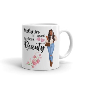 May include: White ceramic mug with a black and white graphic of a woman with brown hair and a white shirt. The text on the mug reads "Melanin Infused ageless Beauty" with two pink hearts.