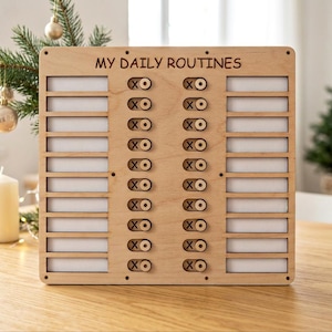 May include: A light-colored wooden routine tracker board with the text MY DAILY ROUTINES engraved at the top. It features two vertical columns of ten sliding toggles, each marked with an X and an O, alongside blank white rectangular slots.