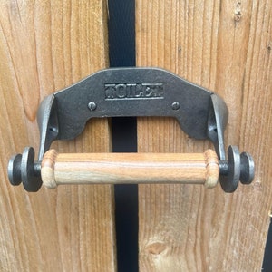 Antique Cast Iron TOILET Roll Holder with a wooden spindle to hold the roll.