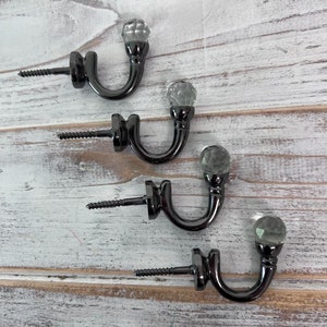 Four Black Screw In Curtain Tie-Back Hooks finished off with a Sparkling Gemstone