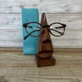 Nose shaped wooden spectacle holder