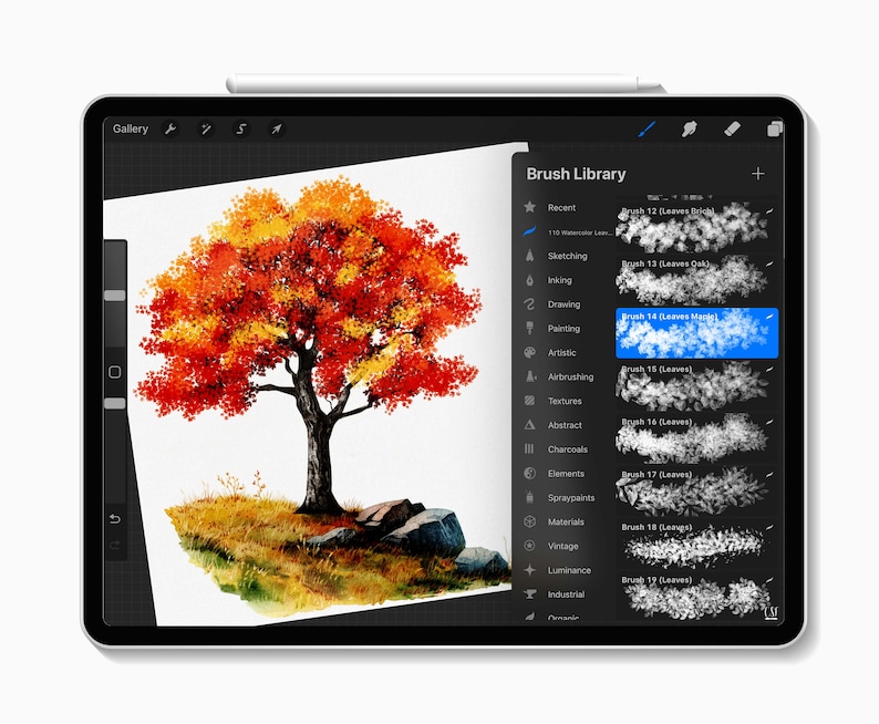 May include: A digital painting of a tree with vibrant red and yellow leaves on a tablet screen. The tree is set against a white background with a grassy area and rocks at the base. The screen displays a brush library.
