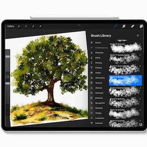 May include: A digital painting of a tree on a tablet screen. The artwork features a detailed watercolor style with a green and brown color palette. The tablet's interface shows a brush library with various brush options for digital art.