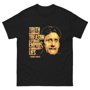 May include: Black t-shirt with a yellow graphic print of a man's face and the text "Truth is treason in an empire of lies - George Orwell".