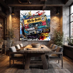 May include: A large canvas print featuring a colorful, graffiti-style illustration of a cassette tape. The tape is labeled "90's Hip Hop Mix" and is set against a backdrop of paint splatters in various colors. The artwork is displayed in a dining room.