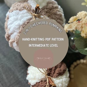 May include: Two handmade, checkered pumpkins in shades of brown and white, tied with twine and a twig stem. The image includes text that reads "2-IN-1 CHECKERED PUMPKINS, HAND-KNITTING PDF PATTERN, INTERMEDIATE LEVEL."