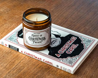 Set regalo con libro di canti natalizi e candela profumata all'arancia e spezie.
