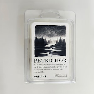 May include: A white wax melt package in a clear plastic clamshell. The label features a black and white landscape illustration with the word "PETRICHOR" and descriptive text. The brand name "VALIANT" is also visible.