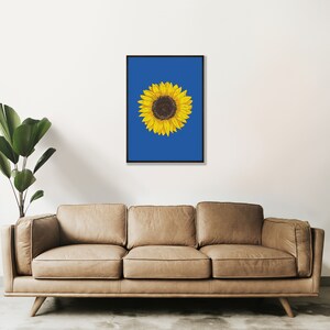 May include: A single sunflower with yellow petals and a dark brown center is drawn on a solid blue background. The image is framed in black.