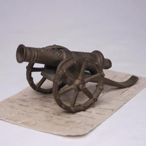 Vintage brass cannon on wheels miniature Artillery cannon Military cannon
